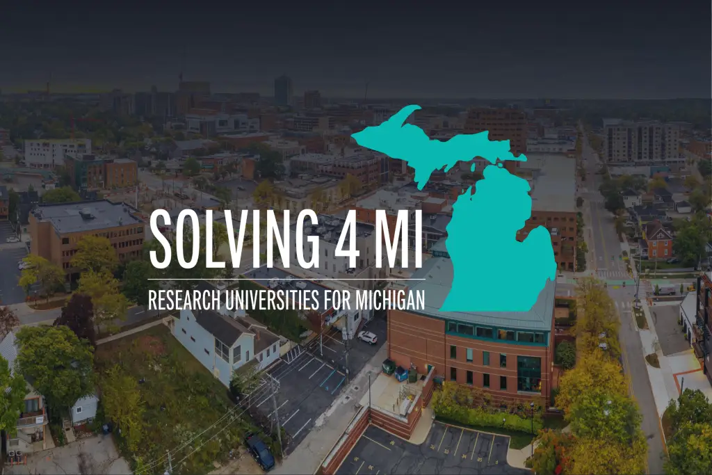 Aerial view of downtown Ann Arbor, Michigan with the Solving 4 MI logo